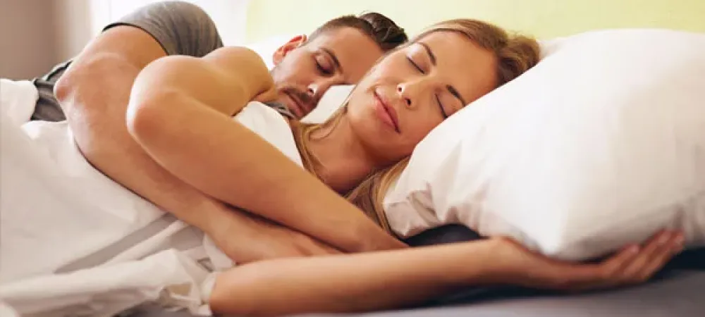 Couple sleeping soundly in bed
